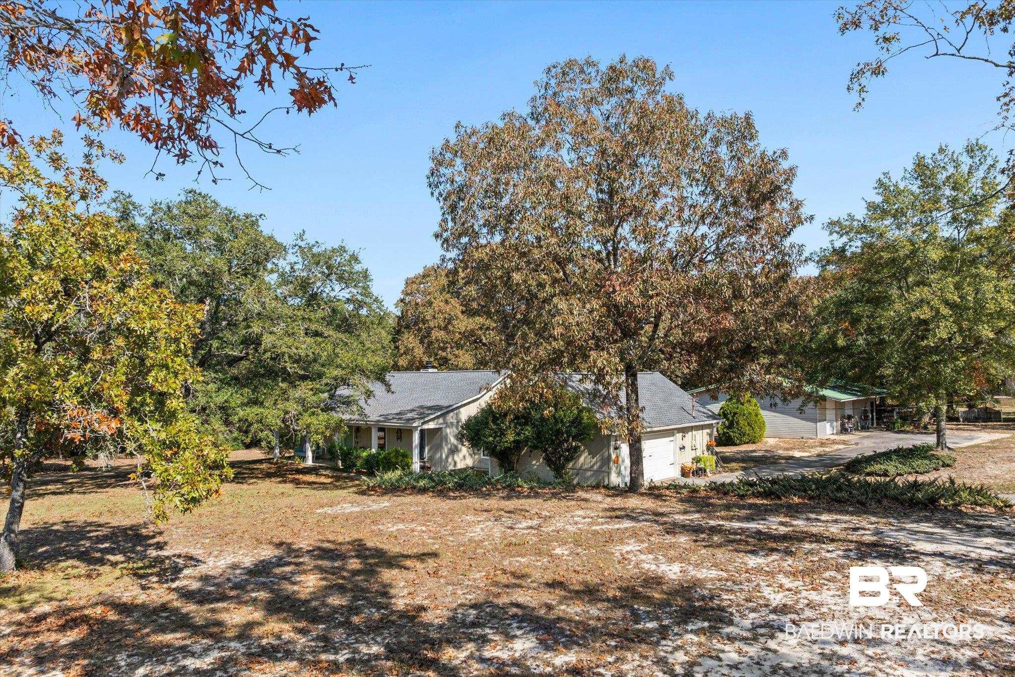 3846 Leslie Road Saraland, AL 36571 - Photo 4 of 40 View of yard featuring a garage and view of wooded area