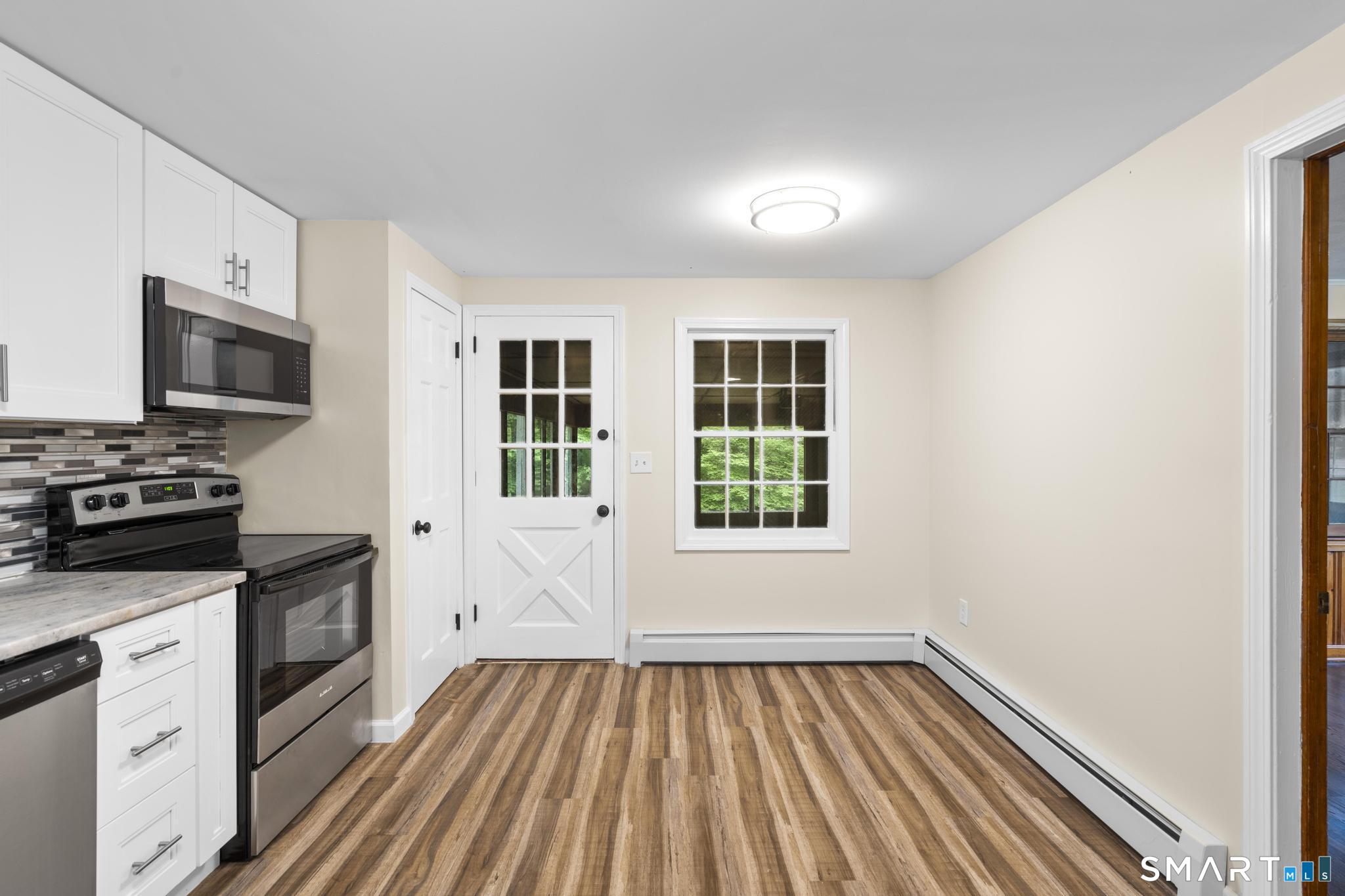 7 Sycamore Terrace Windham, CT 06280 - Photo 12 of 40 a kitchen with wooden floors and wide window