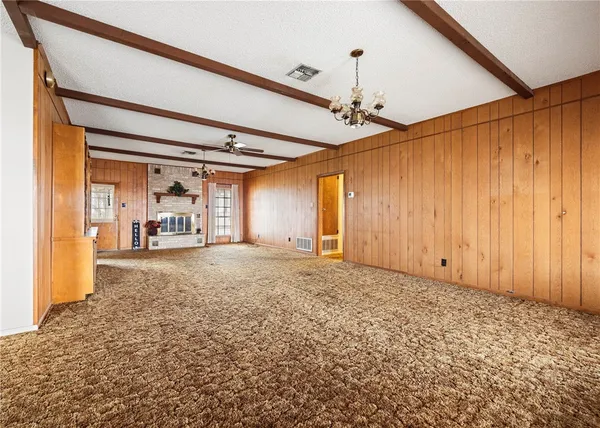 a living room with a fireplace and wooden floor