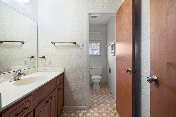 a white toilet sitting next to a shower curtain