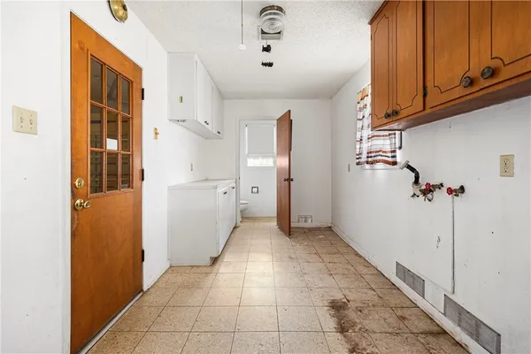 a kitchen with a sink window and cabinets