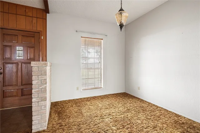 a large kitchen with stainless steel appliances granite countertop a large counter top a stove and a refrigerator