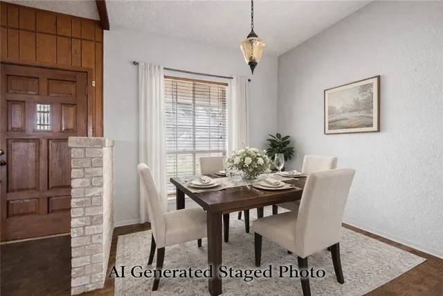 a kitchen with stainless steel appliances granite countertop a sink a stove and a wooden floor