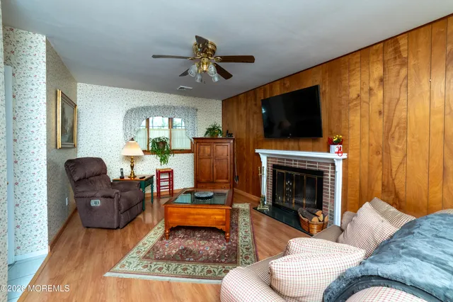 a living room with furniture a flat screen tv and a fireplace