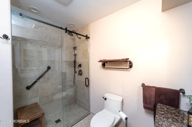 a bathroom with a toilet and a shower