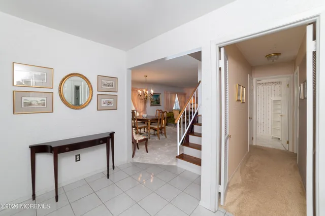 a view of a hallway to a livingroom and a dinning area with furniture