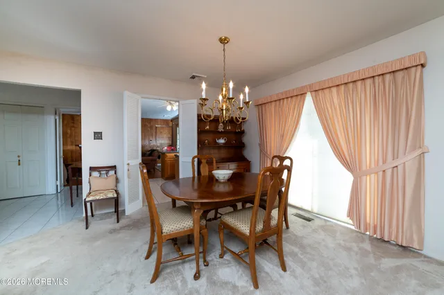 a dining room with furniture and window