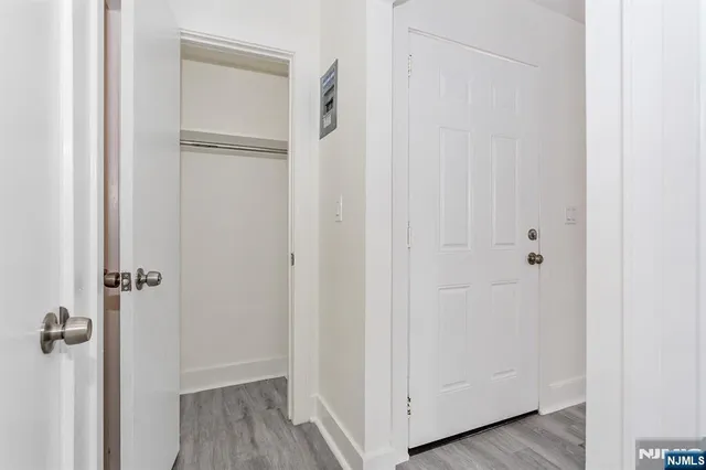 a view of a room with wooden floor