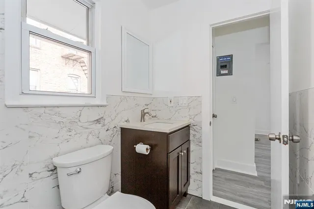 a bathroom with a sink toilet and vanity