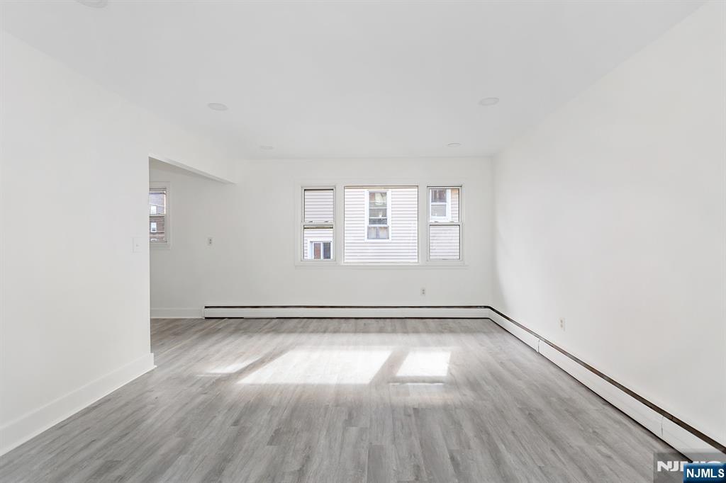86 Chestnut Street, Unit 2 Rutherford, NJ 07070 - Photo 6 of 20 an empty room with wooden floor and windows