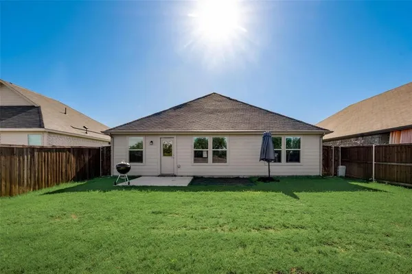 a view of a house with a yard and sitting area