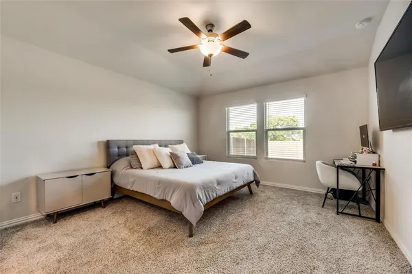 a spacious bedroom with a bed and a window