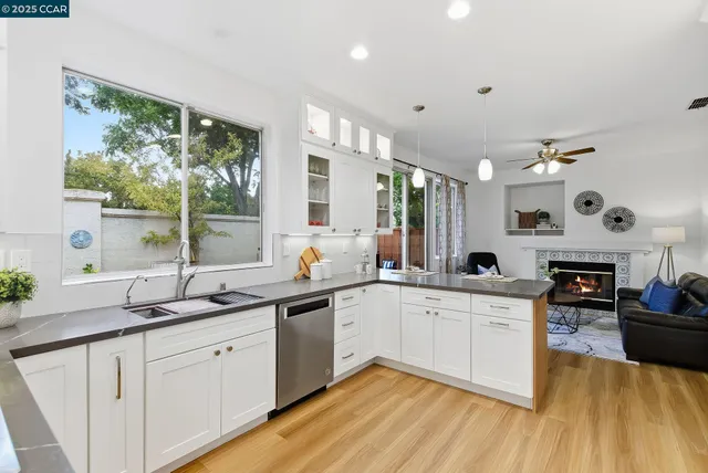 a kitchen with stainless steel appliances granite countertop sink stove top oven and cabinets