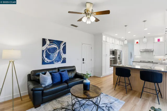 a living room with furniture and kitchen view