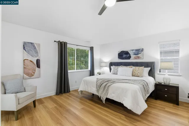 a bedroom with a bed a couch and a window