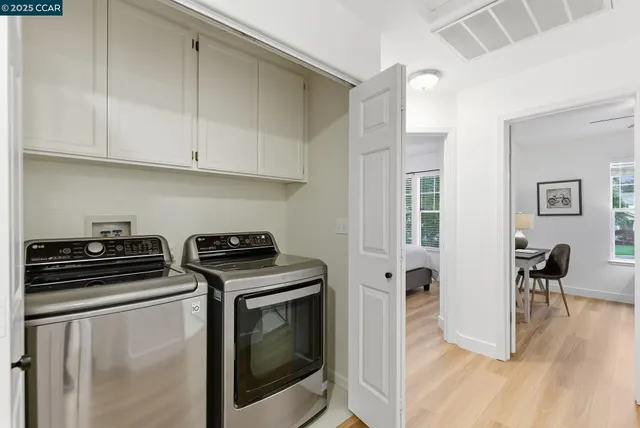 a kitchen with a stove and white cabinets