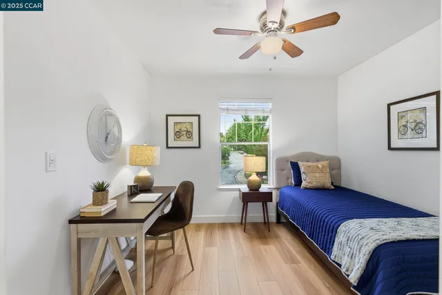 a living room with a bed furniture and a window