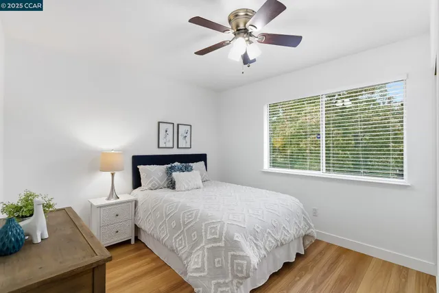 a bed sitting in a bedroom next to a window