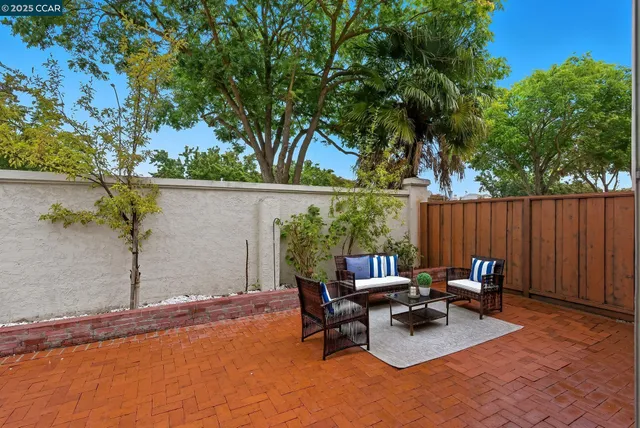 a view of backyard with outdoor seating and trees