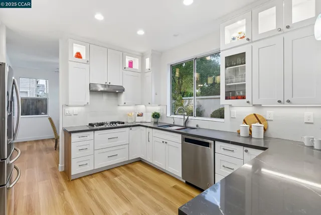 a kitchen with a sink stove and cabinets