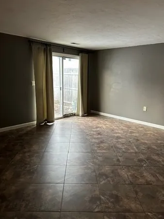 a view of an empty room with glass door