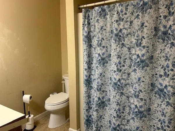 a bathroom with a toilet sink shower and mirror