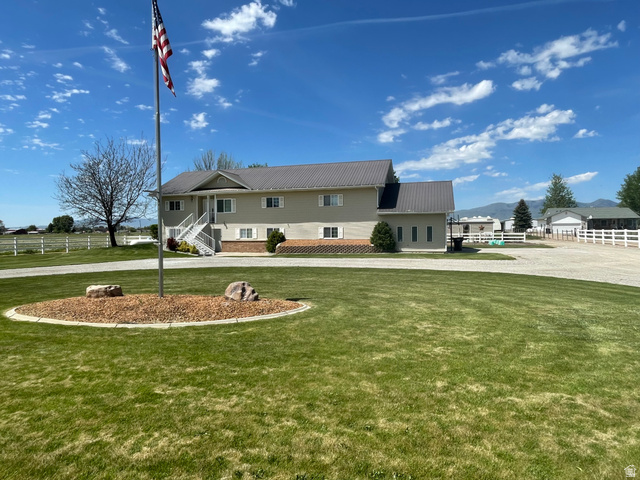 Expansive green lawn with a central mulched garden bed