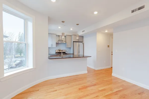 a view of kitchen with wooden floor and window