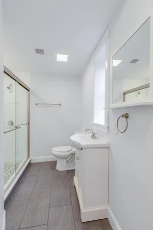 a bathroom with a toilet sink and mirror