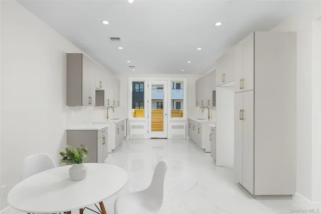 a view of kitchen with furniture and refrigerator