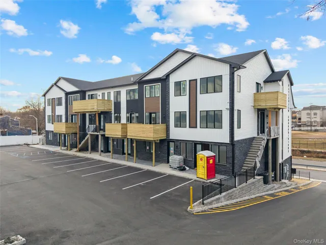 a view of a house with wooden fence