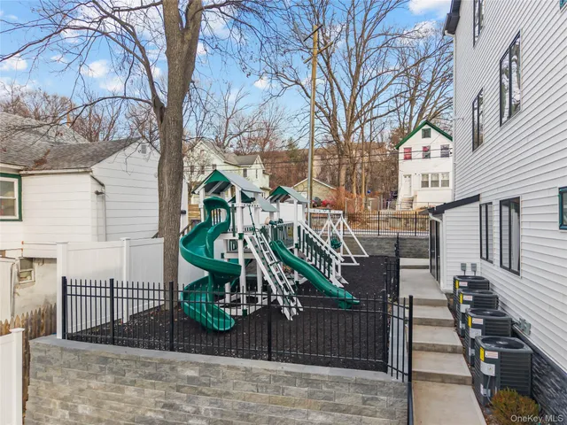 a front view of a residential apartment building with a yard