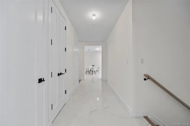 a view of a hallway with closet and a couch