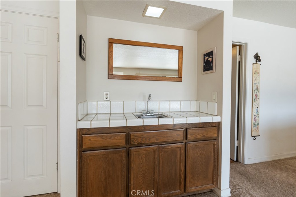 17656 Mockingbird Hill Circle Riverside, CA 92504 - Photo 12 of 49 a bathroom with a sink and a mirror
