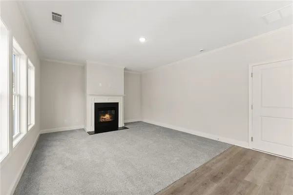 an empty room with a fireplace and window