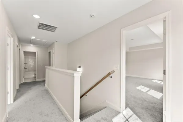 a view of a hallway with a bathroom