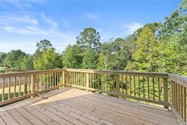 a balcony with wooden floor and fence