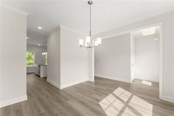 a view of a room with wooden floor and a ceiling fan