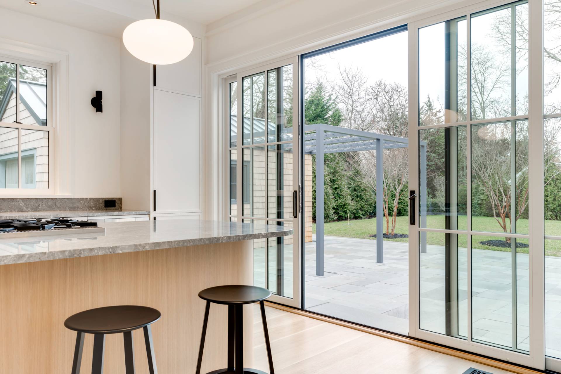 27 Sunset Road Sag Harbor, NY 11963 - Photo 14 of 45 a kitchen with stainless steel appliances granite countertop a stove a sink and a cabinets next to a window