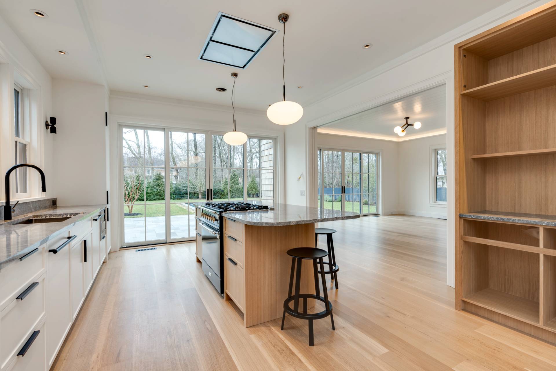 27 Sunset Road Sag Harbor, NY 11963 - Photo 15 of 45 a kitchen with kitchen island a large counter top space a sink stainless steel appliances and cabinets