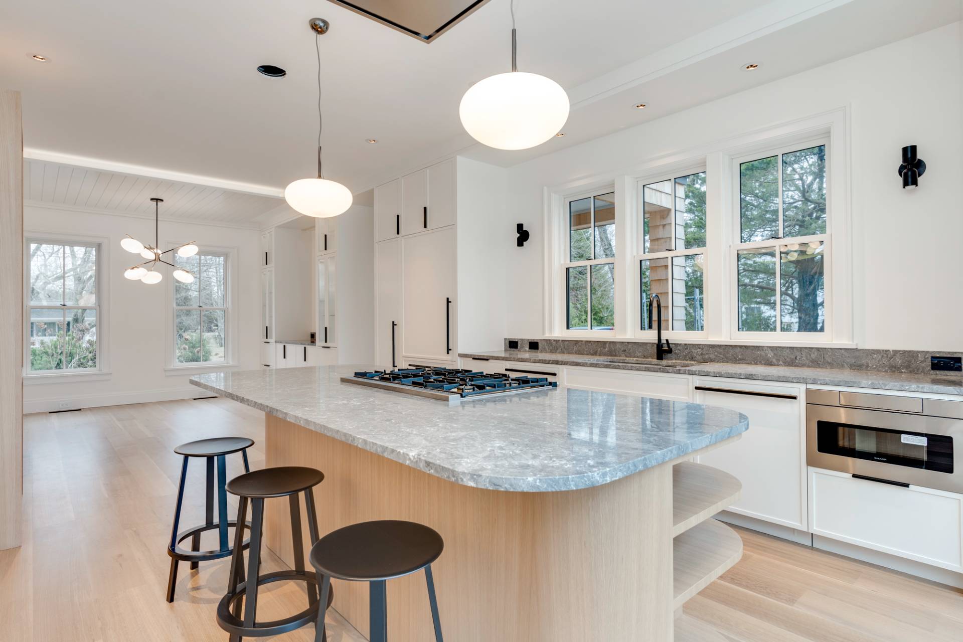 27 Sunset Road Sag Harbor, NY 11963 - Photo 16 of 45 a kitchen with stainless steel appliances granite countertop a table chairs sink and cabinets