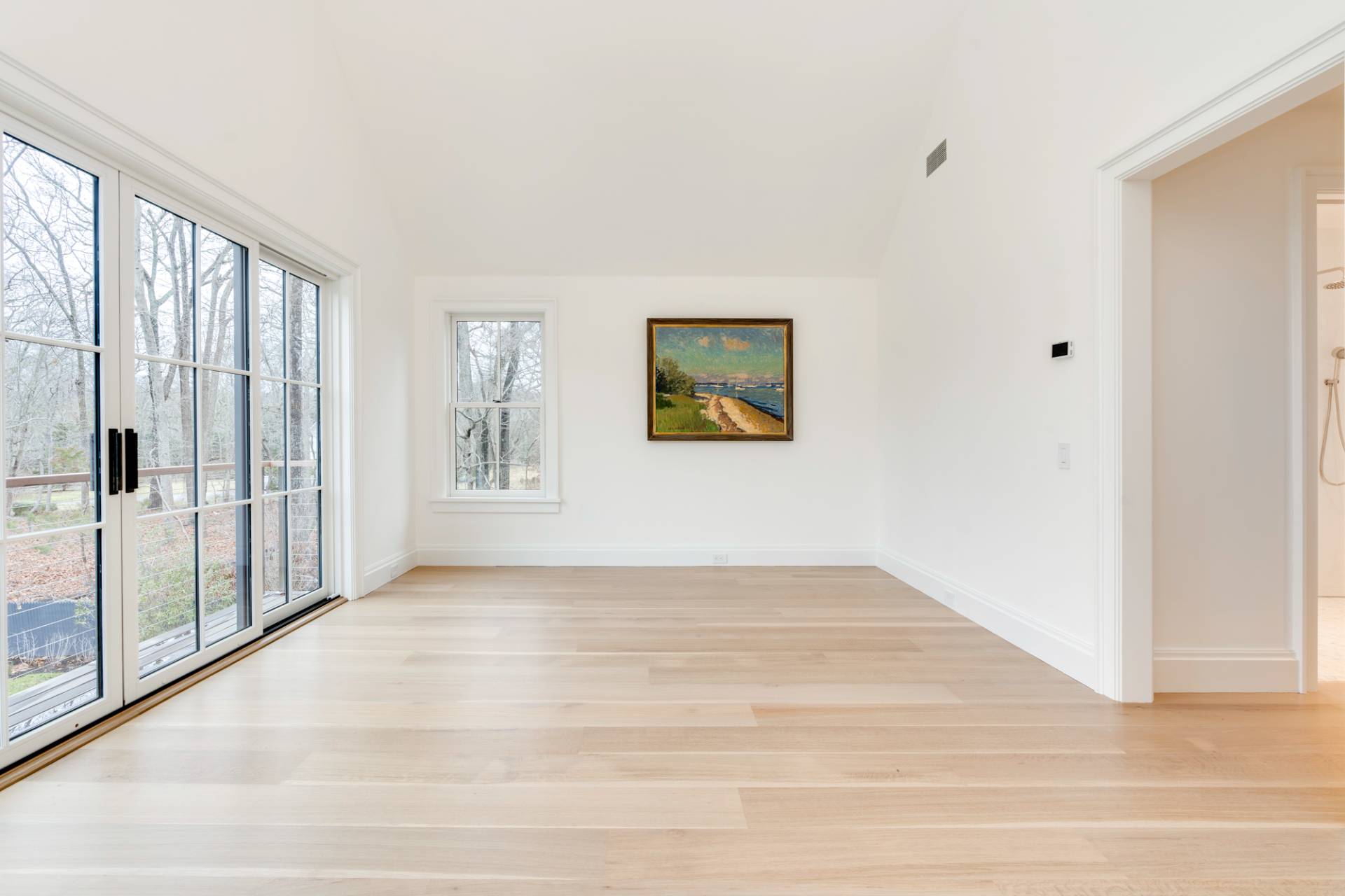 27 Sunset Road Sag Harbor, NY 11963 - Photo 25 of 45 a view of an empty room with wooden floor and a window