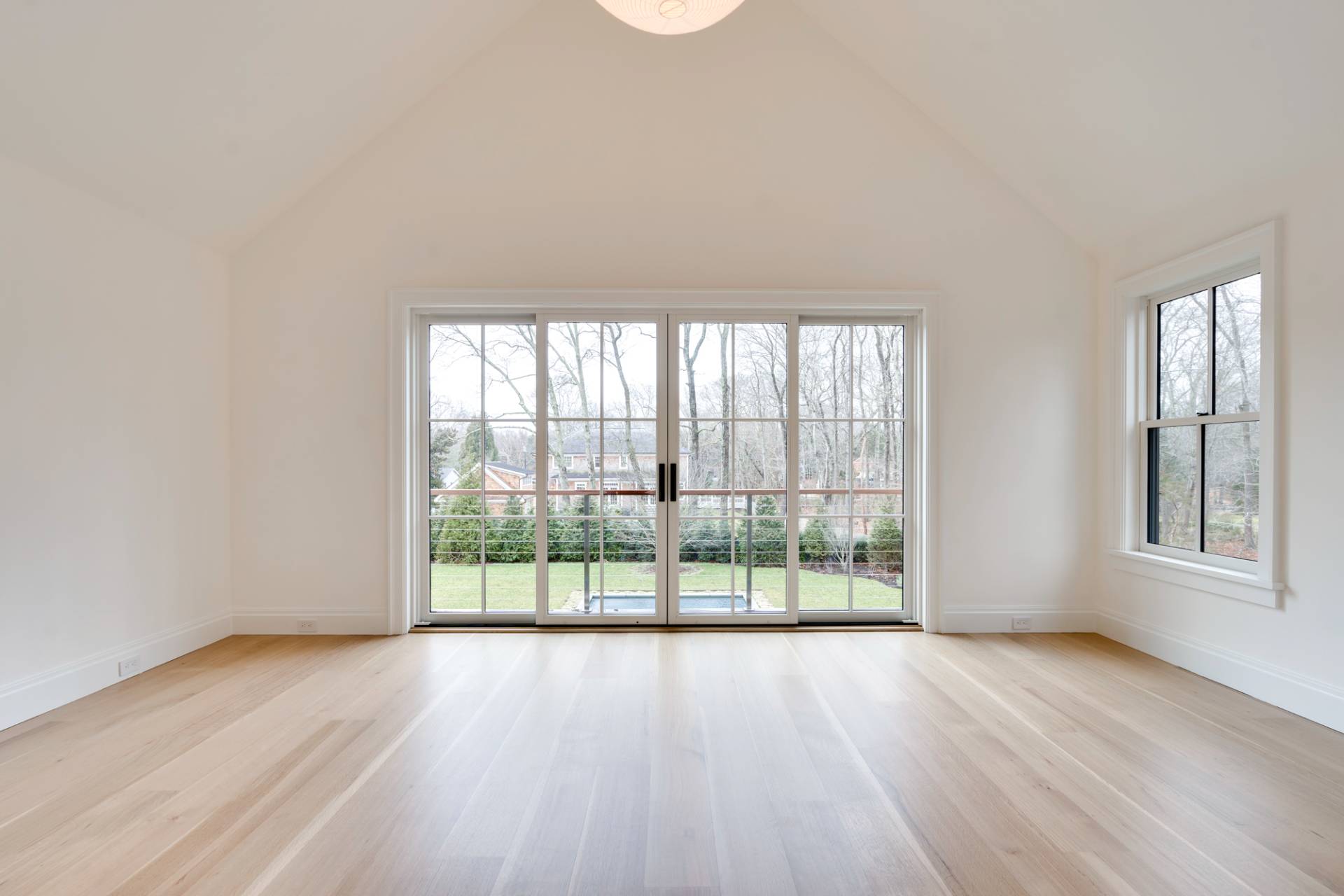 27 Sunset Road Sag Harbor, NY 11963 - Photo 26 of 45 an empty room with wooden floor and windows