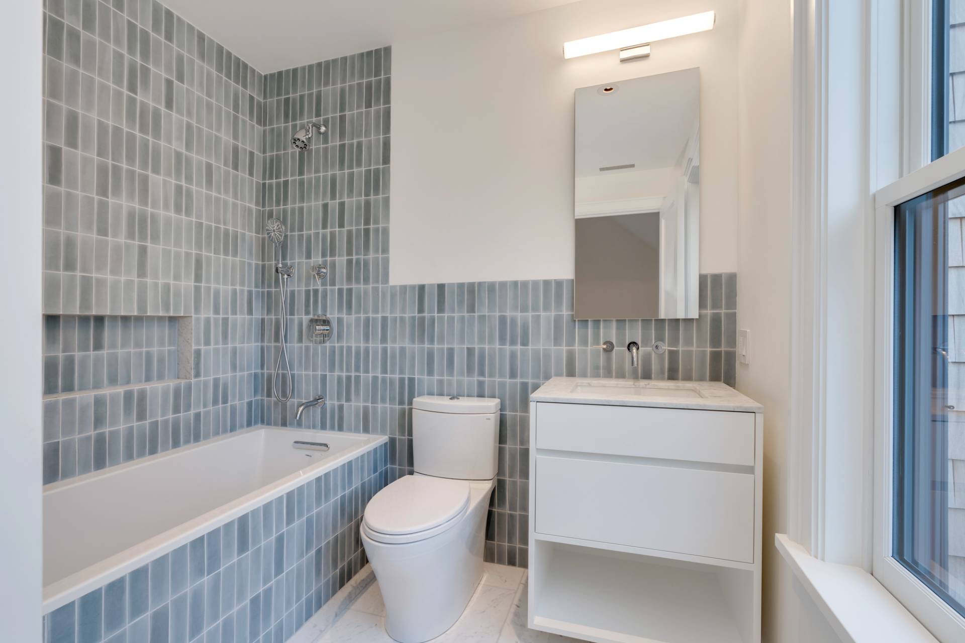 27 Sunset Road Sag Harbor, NY 11963 - Photo 30 of 45 a bathroom with a sink a toilet and bathtub