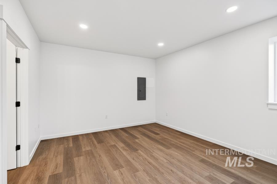 1298 Edington Moscow, ID 83843 - Photo 20 of 32 Wood-finish flooring, recessed lighting, white walls, and a window with white trim