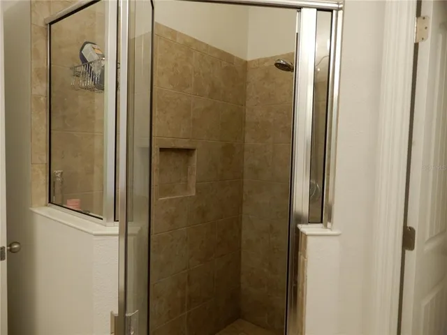 a bathroom with a glass shower door