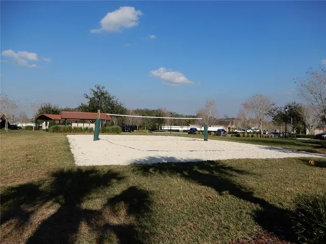 a view of swimming pool with outdoor seating and covered with trees