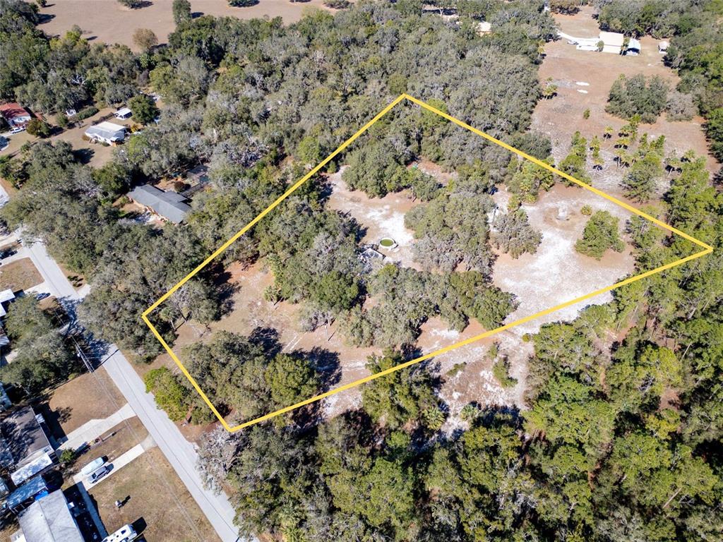 8725 Treasure Island Road Leesburg, FL 34788 - Photo 25 of 27 a view of a wooden bridge