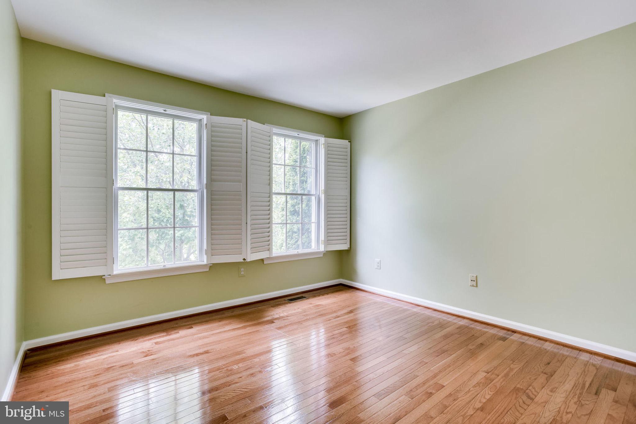 10851 Grovehampton Court Reston, VA 20194 - Photo 31 of 49 an empty room with wooden floor and windows
