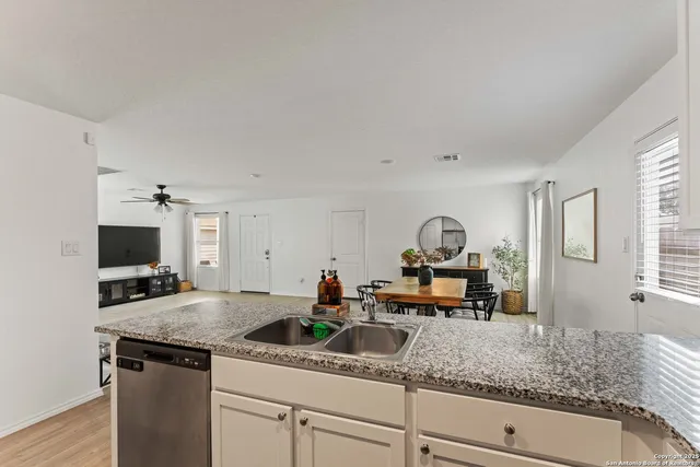 a kitchen with granite countertop a sink and a stove top oven